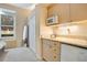 Bedroom wet bar featuring a sink, microwave, and mini-fridge, perfect for guests or a convenient retreat at 1935 Lago Vista Blvd, Palm Harbor, FL 34685