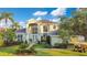 Elegant home featuring mature landscaping, a lush lawn and large windows that provide plenty of natural light at 1935 Lago Vista Blvd, Palm Harbor, FL 34685