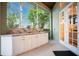 Screened outdoor kitchen with counter space, enhancing outdoor cooking and entertainment opportunities at 1935 Lago Vista Blvd, Palm Harbor, FL 34685