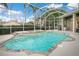 Enclosed pool area with crystal clear water and fountain, enhancing the backyard with resort style experience at 1935 Lago Vista Blvd, Palm Harbor, FL 34685
