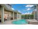 Screened pool offers private outdoor enjoyment, complemented by a spa and elegant patio furnishings at 1935 Lago Vista Blvd, Palm Harbor, FL 34685