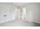 Spacious bedroom showcasing multiple doorways, neutral color scheme, and ample lighting at 4817 Majestic Hills Loop, Brooksville, FL 34601