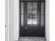 Black front door with glass panels and sidelights at 4817 Majestic Hills Loop, Brooksville, FL 34601