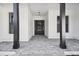 Brick paved porch with black columns and a black front door at 4817 Majestic Hills Loop, Brooksville, FL 34601