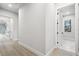 Bright hallway with wood-look flooring leading to various rooms with natural light at 4817 Majestic Hills Loop, Brooksville, FL 34601