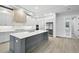 Modern kitchen featuring an island, stainless steel appliances, white countertops, and gray lower cabinets at 4817 Majestic Hills Loop, Brooksville, FL 34601