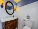 Charming half bathroom with marble countertop vanity, decorative mirror and wainscoting at 5455 Lake Le Clare Rd, Lutz, FL 33558