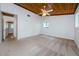An airy carpeted bedroom offers a ceiling fan, wood ceiling, two closets and a window to bring the outdoors in at 5455 Lake Le Clare Rd, Lutz, FL 33558