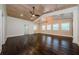 Expansive bedroom with hardwood floors, wood-paneled ceiling, and natural light from large windows at 5455 Lake Le Clare Rd, Lutz, FL 33558