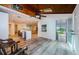 Open concept kitchen with white cabinets, an island with seating, and wood look floors at 5455 Lake Le Clare Rd, Lutz, FL 33558