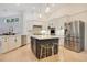 Modern kitchen island with seating and stainless steel appliances at 1935 Lago Vista Blvd, Palm Harbor, FL 34685