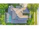 Bird's eye view of the house, highlighting the roofline and pool at 1935 Lago Vista Blvd, Palm Harbor, FL 34685