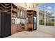 Wet bar with wood cabinetry, wine storage, and a large window at 1935 Lago Vista Blvd, Palm Harbor, FL 34685