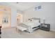 Elegant main bedroom with king-size bed and ensuite bathroom access at 1935 Lago Vista Blvd, Palm Harbor, FL 34685