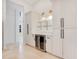 Butler's pantry with wine cooler and glass shelving at 1935 Lago Vista Blvd, Palm Harbor, FL 34685