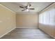 Spacious living room with wood-look floors and large windows at 1877 Pine Cone Cir, Clearwater, FL 33760