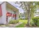 Two-story condo building with red tile roof and landscaping at 1877 Pine Cone Cir, Clearwater, FL 33760