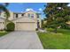 Townhouse with two-car garage and landscaped front yard at 8643 Corinthian Way, New Port Richey, FL 34654