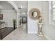 Bright entryway with tile floors, a sunburst mirror, and a view to the dining area at 8643 Corinthian Way, New Port Richey, FL 34654