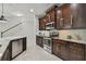 Modern kitchen with dark wood cabinets and stainless steel appliances at 8643 Corinthian Way, New Port Richey, FL 34654