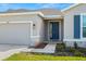 House exterior showing front door, walkway, and landscaping at 13862 Whiskey Daisy Dr, Dade City, FL 33525