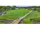 Aerial view of a golf course with a wooden bridge over a waterway at 10534 Collar Dr, San Antonio, FL 33576