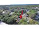 Scenic aerial view of a lakeside home surrounded by verdant trees and a calm waterfront at 1155 7Th N St, Safety Harbor, FL 34695