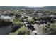 Aerial view of the neighborhood, showcasing mature trees, residential streets and nearby body of water at 1155 7Th N St, Safety Harbor, FL 34695