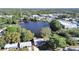 An aerial view of the property including a lake, a building with a red antenna and the neighborhood at 1155 7Th N St, Safety Harbor, FL 34695