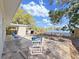 Spacious backyard featuring a waterfront view, a wooden fence, storage shed, and outdoor seating at 1155 7Th N St, Safety Harbor, FL 34695