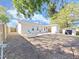 Spacious backyard with an open patio, two blue chairs, shed, and wood fence at 1155 7Th N St, Safety Harbor, FL 34695