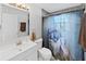 Bathroom with a unique monkey shower curtain and white vanity at 1155 7Th N St, Safety Harbor, FL 34695