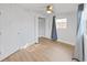 Bedroom with hardwood floors, window with curtain, closet, and entry door at 1155 7Th N St, Safety Harbor, FL 34695