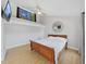 Cozy bedroom with a loft, ceiling fan, wood floors and a mounted TV at 1155 7Th N St, Safety Harbor, FL 34695