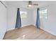 Bedroom with hardwood floors, and two windows with curtains at 1155 7Th N St, Safety Harbor, FL 34695
