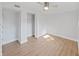Bright bedroom featuring a ceiling fan, wood floors, and a closet with folding doors at 1155 7Th N St, Safety Harbor, FL 34695