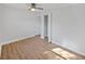 Bright bedroom featuring a ceiling fan, wood floors, and a closet with folding doors at 1155 7Th N St, Safety Harbor, FL 34695