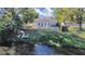 An aerial view of the backyard, including a kayak and chairs, a wooden fence and the back of the house at 1155 7Th N St, Safety Harbor, FL 34695