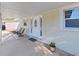 Inviting front porch with seating and a decorative glass front door at 1155 7Th N St, Safety Harbor, FL 34695