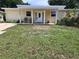 Inviting home featuring a covered front porch and a well-kept lawn at 1155 7Th N St, Safety Harbor, FL 34695