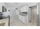 Open kitchen has tile floors, granite countertops and white cabinets at 1155 7Th N St, Safety Harbor, FL 34695