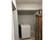 Bright laundry area with modern washer, overhead vent, tiled floor, and storage cabinet at 1155 7Th N St, Safety Harbor, FL 34695