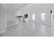 Bright living area flowing into a modern kitchen with stainless steel appliances, creating a seamless living experience at 1155 7Th N St, Safety Harbor, FL 34695