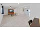 Bright living room with tile flooring, ceiling fan, and a decorative console underneath the television at 1155 7Th N St, Safety Harbor, FL 34695