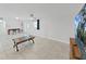 Spacious living room featuring neutral walls, tile flooring, and a ceiling fan providing a bright and airy atmosphere at 1155 7Th N St, Safety Harbor, FL 34695