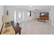 Bright living room with tile flooring, ceiling fan, and a decorative console underneath the television at 1155 7Th N St, Safety Harbor, FL 34695