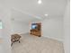 Spacious living area featuring tile flooring, ceiling fan, and a decorative console underneath the television at 1155 7Th N St, Safety Harbor, FL 34695