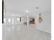 Spacious living room features tile flooring, a ceiling fan, and white walls enhancing its bright and airy ambiance at 1155 7Th N St, Safety Harbor, FL 34695