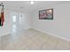 Minimalist living room featuring gray walls, tiled floors, and an open layout, creating a clean and modern aesthetic at 1155 7Th N St, Safety Harbor, FL 34695