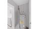 Utility room featuring a hot water heater, washing machine, and gray paint at 1155 7Th N St, Safety Harbor, FL 34695
